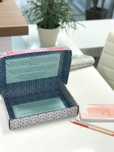 a decorated box opened to reveal a typed letter as part of the interior printing